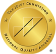 Gold circular seal displaying "The Joint Commission National Quality Approval" with a stylized geometric logo in the center—ideal for showcasing accreditation on your WordPress footer using Elementor.